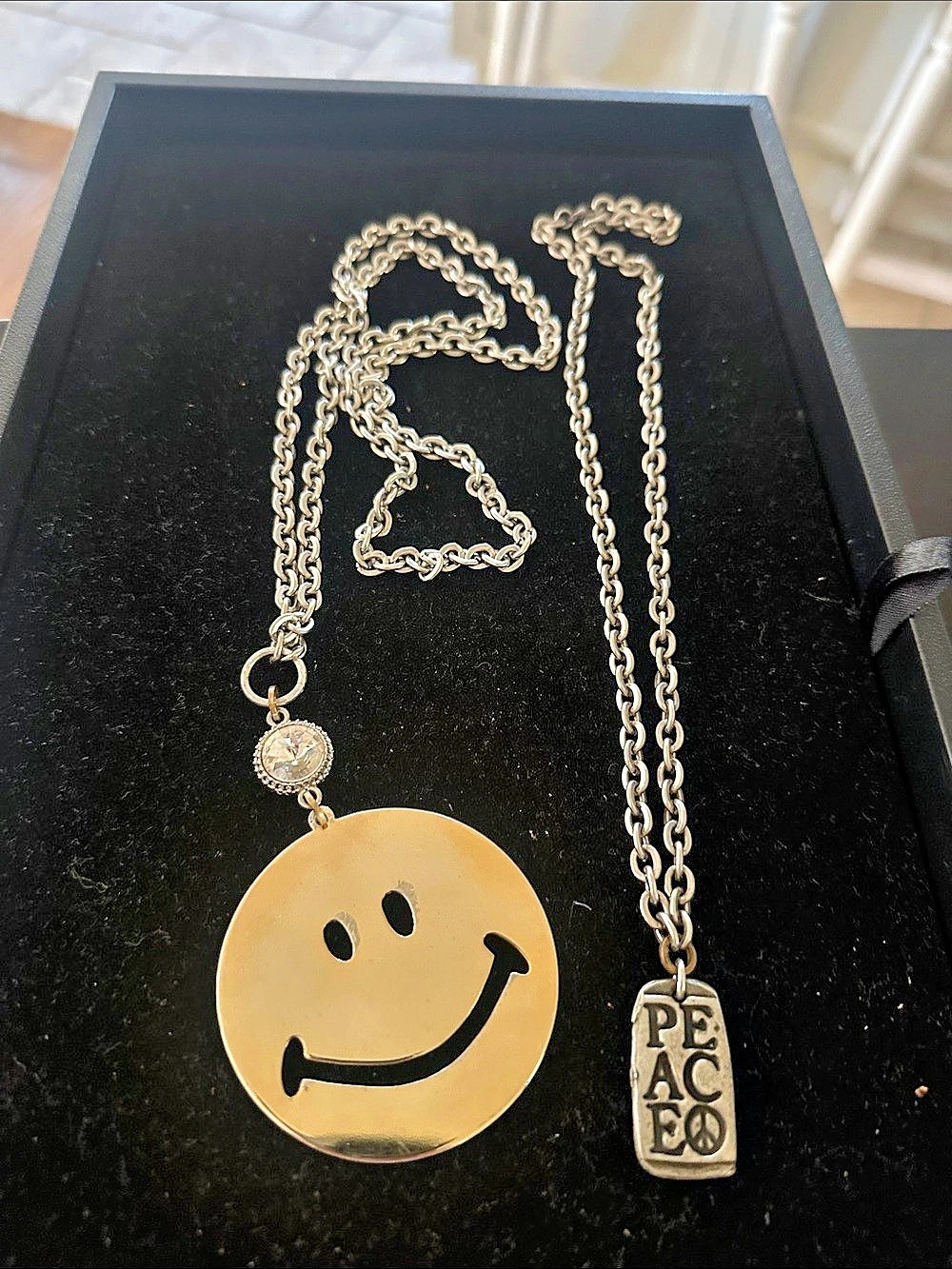 Set of happy face and peace necklaces